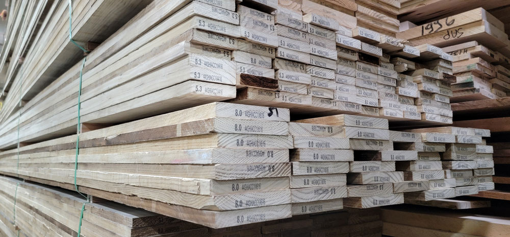 Regraded Accoya Lumber with the Hardwood Industries grade stamp and board footage calculation on the end of each board.